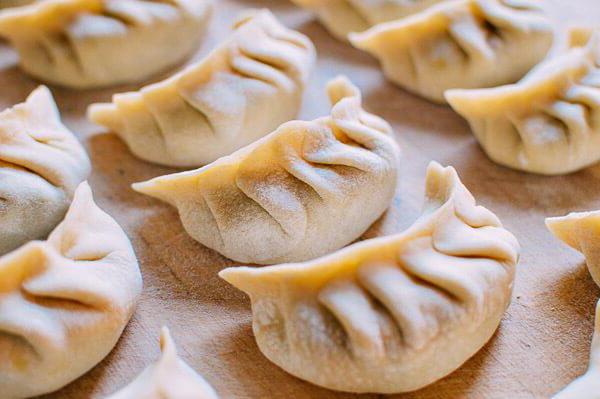 Fried dumplings with onions, potatoes and mushrooms